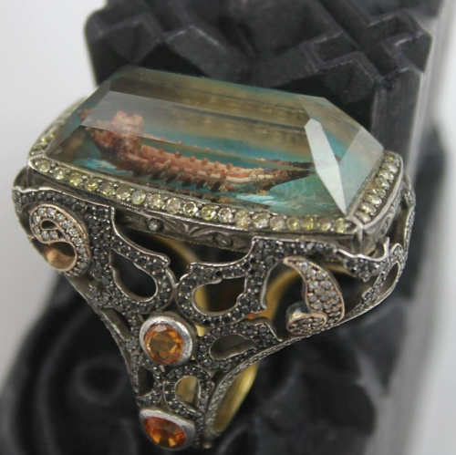 digg:  Sevan Bıçakçı makes RIDICULOUS jewelry. The images within the itmes are created by carving a 3D object out of the underside of the gem. Via Daily Dot 