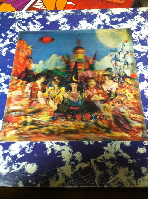 scoop16:  My scratched and beat up copy of The Rolling Stones ‘Their Satanic Majesties Request’. The faces of 4 hidden Beatles(John, Paul, George, & Ringo) can be found on this 3D cover. Later versions featured a cropped picture omitting the 4