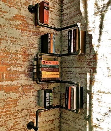 A bookshelf make of pipes add extra character yet fit right in with exposed brick walls.