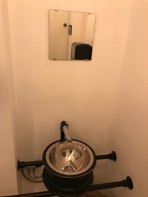 unisex restroom at a local restaurant in lebbeke. The sink is for both men and woman and is in the s