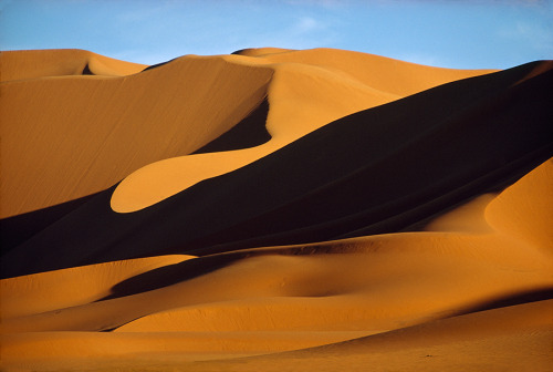 The wind sculpts the dunes of the Sahara Desert in the Erg Bourarhet, Algeria, 1973. Photograph by T