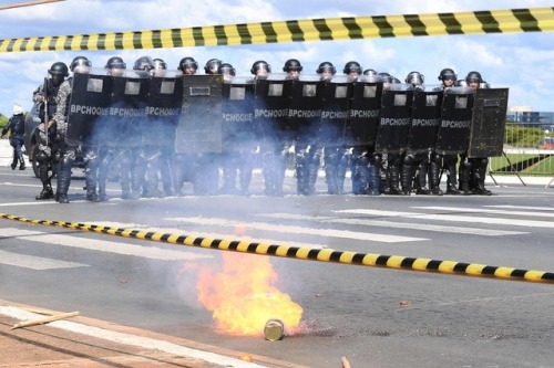 Riot police are seen during clashes in a protest against the labor and social security reforms and t