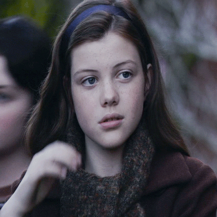 lucy + tucking her hair behind her ears