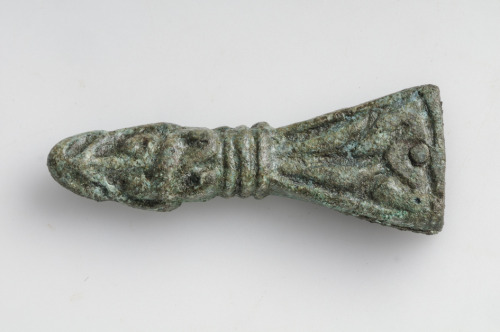 Strap-end Bronze Shaped as an animal or some kind of mythological creature. Grave find, Skälby, Hägg