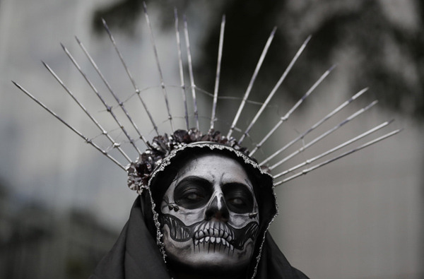 harvestheart:  A costumed woman awaits the start of the Grand Procession of the “Catrinas,”