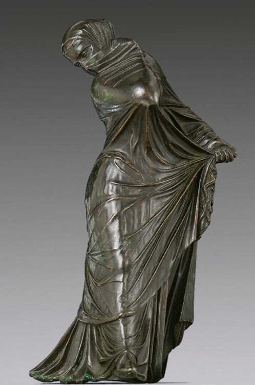 Statuette of a veiled and masked dancer, Hellenistic, 3rd–2nd century b.c.GreekThe complex motion of