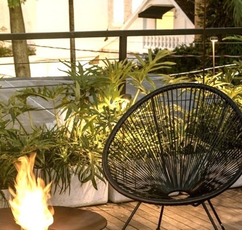 Industrial Deck - DeckPhoto Of A Large Rooftop Deck In An Urban Area With A Fireplace And No Cover.