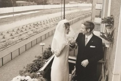 Couple getting married in East Germany and taking a picture on their parents balcony. Not sure of a 