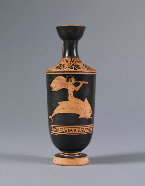 fishstickmonkey:Red-figure Lekythos: Eros Riding a Dolphin and Playing the Double Flutes (Auloi)attr