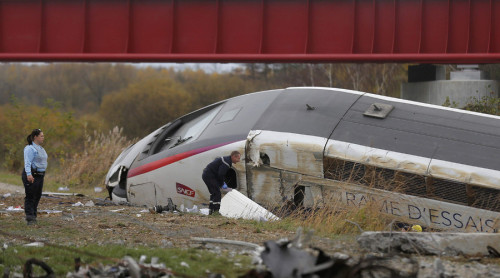 Rescue workers search the wreckage of a test TGV train that derailed and crashed in a canal outside 