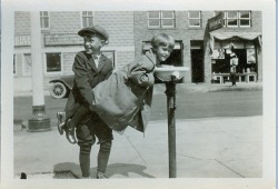 vintageeveryday:  Brother helps younger sister