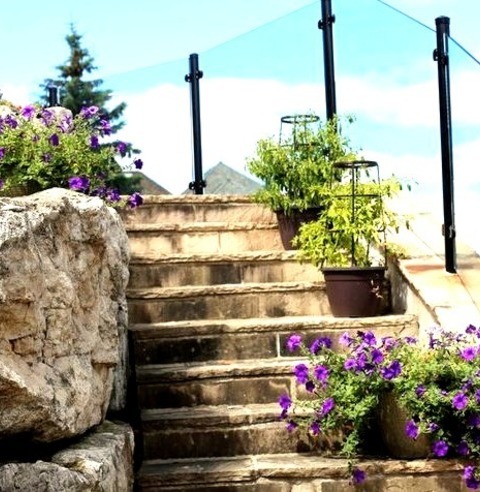 Traditional Patio - PatioLarge Elegant Backyard Stone Patio Container Garden Photo With No Cover