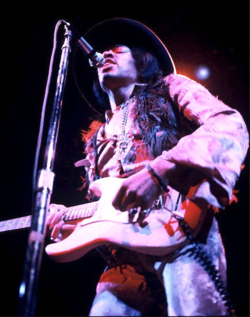 Jimi Hendrix in feather boa and velvet pants, to say the least, Fillmore East 1968, by Don Aters, vi