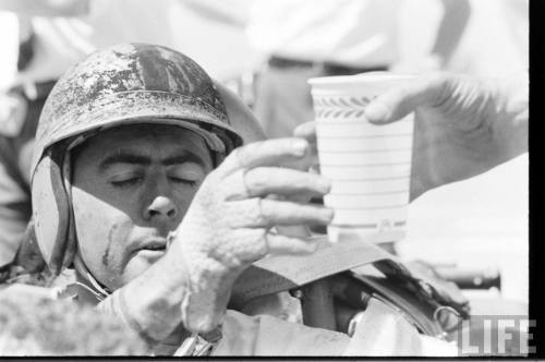 Jack Brabham is handed a drink(Robert W. Kelley. 1961)