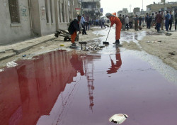 losed:  Iraqi workers clean debris near a