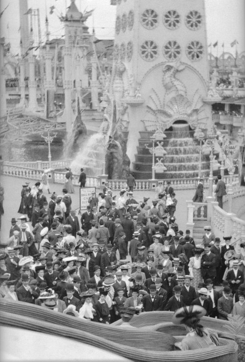 The crowd gathered here watch as visitors, namely the two women seen at the bottom of this photograp