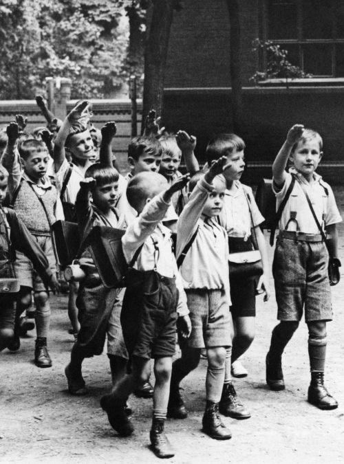 itsjohnsen: Children exit school with the ‘Hitlergruß’. Germany, 1933. Unattribute