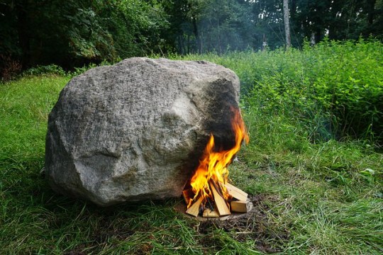 Hollow rock turns into a router full of survival info when you build a fire beside it
