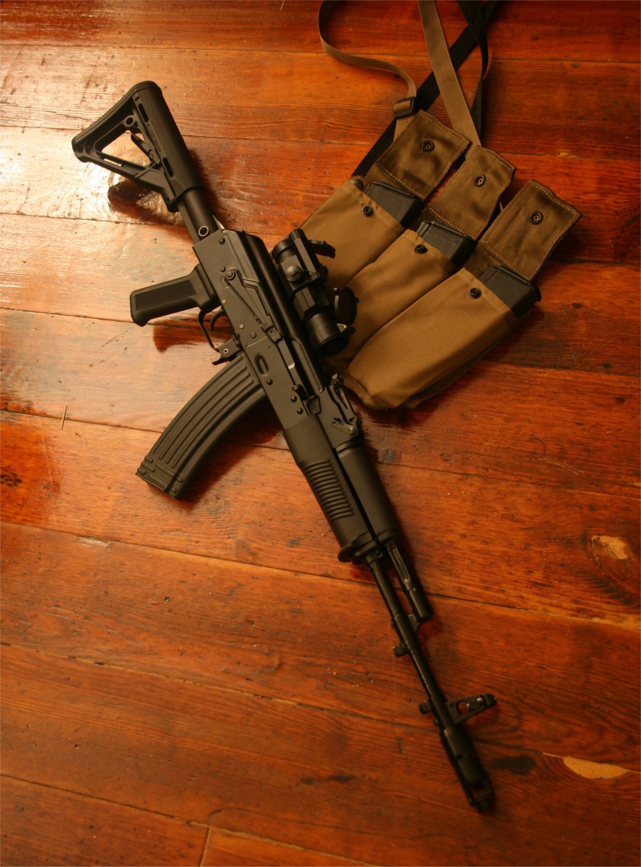 gunsngear:   AK-74  With surplus metal mag. (Polish, I think) The 3 mags in the bandoleer