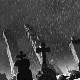 a gif of animated rain falling in a abandoned graveyard