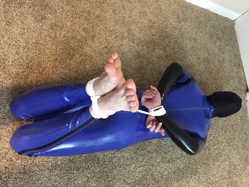 lockedj0ck:  After getting me rubbered up, sir had me present my body and show off my cage. Then he put me in a hog tie, and slowly added more pieces to the predicament. First my knees were tied together to further immobilize me. Then he slid in an anal
