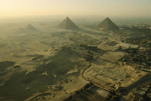 egypt-museum:  Pyramids of Giza  Aerial view of the Pyramids of Giza, the tombs of the pyramid builders, and other excavation sites.Photo: Kenneth Garrett