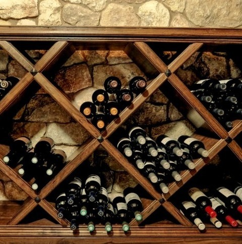 Medium San DiegoWine Cellar - Mid-sized 1960s Travertine Floor Wine Cellar Idea With Display Racks
