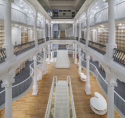 asylum-art:Monochrome BookstoreJust renovated in Bucharest, Romania, this six-story Carousel of Light houses 10,000 books for sale. The building’s 19th Century facade and interior were painstakingly restored with an art gallery on the first floor and