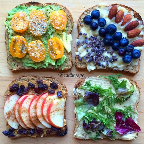 happyvibes-healthylives:  Toast! 4 ways-  avocado, hemp, tomato smashed banana, almonds, blueberries, cacao peanut butter, raisins, apples, cinnamon hummus, dill, red lettuce, lemon 