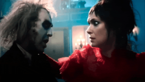 Beetlejuice And Lydia Blowing Kisses At Each Other