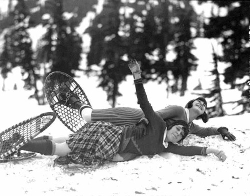 Two girls laying in the snow wearing snow shoes, Mt. Baker, Washington, ca. 1929-1932 via University