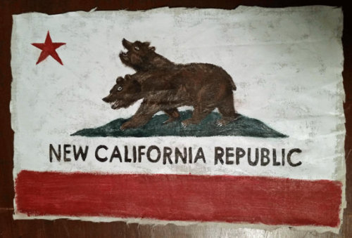 One of the heads of the two-headed bear on the NCR flag wants to remind you to &ldquo;EAT UR MEN