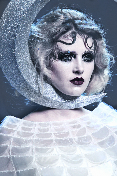 deprincessed: Closeup of a model wearing the most fantastical fascinator echoing a sparkly crescent 