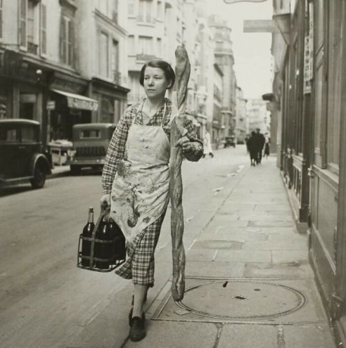 astercrash:through-a-historic-lens:A French Woman With Her Baguette And Six Bottles Of Wine, Paris, 