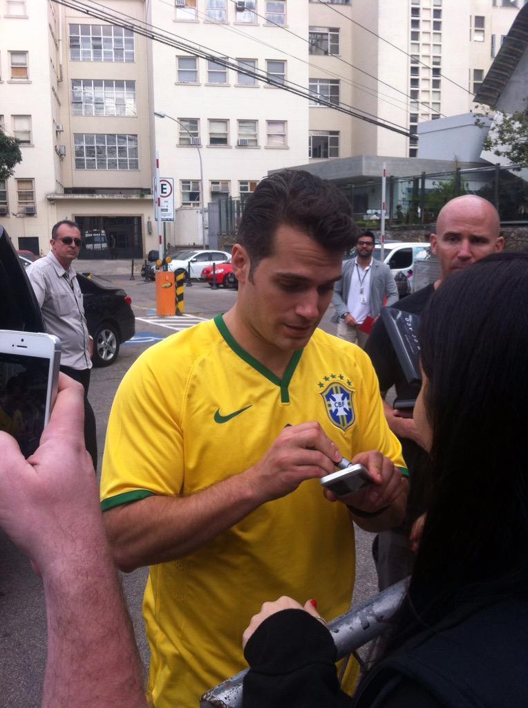 cavillheugh:  Henry Cavill signing autographs in Rio and wearing the football (soccer)