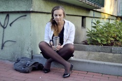 in-pantyhose:  Lovely blonde in black opaque pantyhose and high heels drinking coffee in the street.  Woman in pantyhose