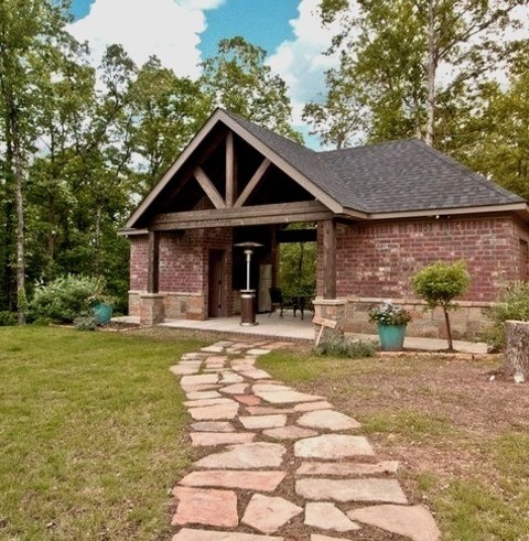 An illustration of a sizable backyard stone patio design in the form of a gazebo