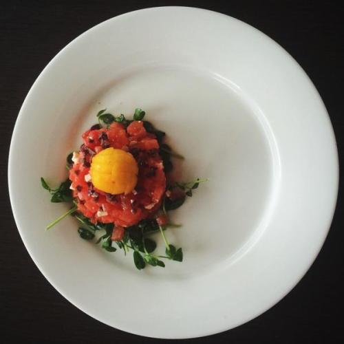 Faux tartare made of compressed watermelon, feta, and kalamata + a peach “yolk”. Source: