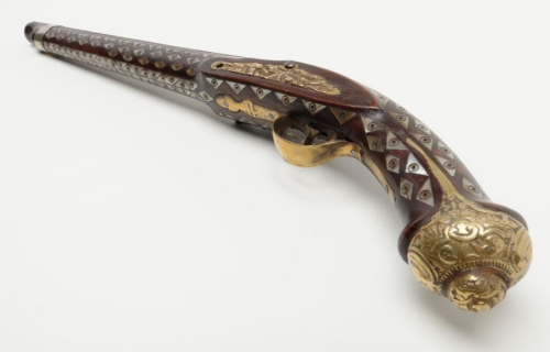 Ornate pearl and brass mounted flintlock pistol originating from North Africa, 19th century.