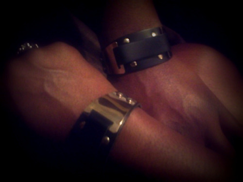 kinkybutterfly:  Matching leather & chrome wrist cuffs! More symbolism… We’re each wearing these beautiful cuffs complete with that intoxicating leather smell and the cold smoothness of motorcycle chrome. I love these! Thank you Sir! 