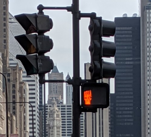 copperbadge:Someone has been running around Chicago, changing Don’t Walk signal lights into solidari