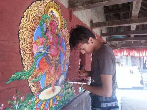 Artist Sudarshan Sinkhwal and friend painting deities at nepali temple.