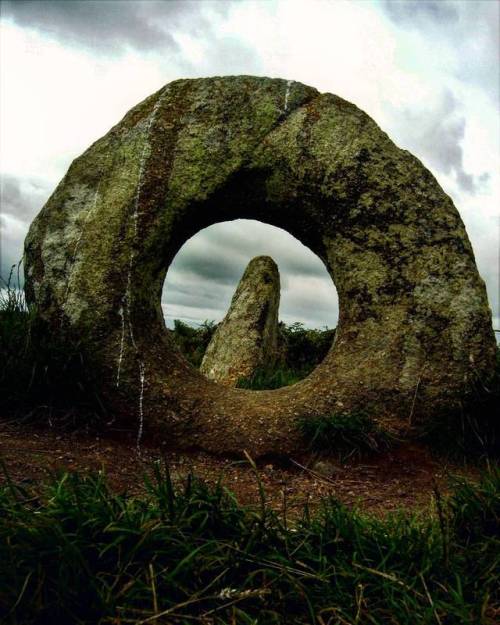 Mên-an-Tol, Madron, Cornwall. The monument consists of four stones: one fallen, two uprights, and be