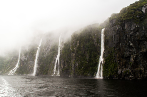 Waterfalls coming out of the clouds at Milford Sound.Milford Sound, Fiordland, South Island, New Zea