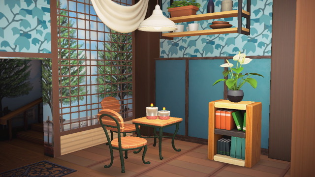 A small display section of a room with said chairs in it, along with a mixed woodblock shelf, a white anthurium plant, a table from the same set as the chairs, topped with two candles, and a ceiling light fixture.