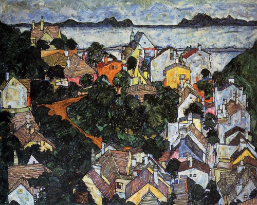 Acrylic landscape painting “Summer Landscape, Krumau” by Egon Schiele depicts the tops of houses and trees grouped together in a way that feels chaotic and claustrophobic with the sketchy lines Shiele is known for. Treetops are dark green, almost black, and the houses all have brownish rooftops with yellow, orange, and pale blue sides. On the top of the painting, past the houses and trees, is a body of pale blue water, with dark green hills and a pale blue sky. The colors are not solid, with blues featuring greens, pinks, and yellows, creating texture and shadow.
