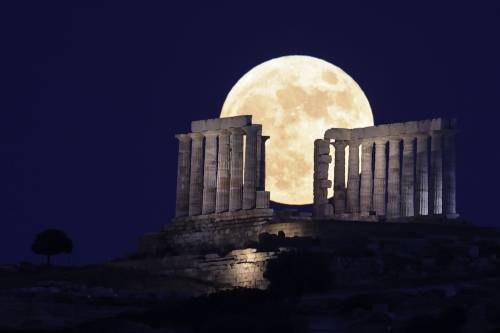 misterlemonzafterlife:  peacephotography:  A full moon, also known as the Strawberry Moon, rises behind Temple of Poseidon, near capital city AthensPhotograph: Anadolu Agency https://MisterLemonzAfterlife.tumblr.com/archive