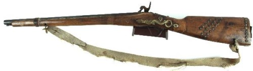 A percussion Northwest Trade Musket with tack decorations, mid 19th century.Produced in England the 