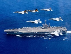 planesawesome:Super Hornets flying over the USS John C. Stennis (CVN 74).