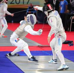 modernfencing: [ID: a foilist hitting his opponent just before going off-strip.] Maxime Pauty (left)  against Askar Khamzin at Cairo 2017! Photo by Devin Manky. 